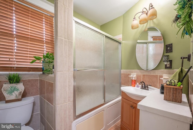4800 Illinois Ave NW, Washington, DC 20011 - bathroom with tile walls, toilet, vanity, and enclosed tub / shower combo