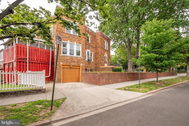 4800 Illinois Ave NW, Washington, DC 20011 - view of front facade with an attached garage, concrete driveway, and brick siding