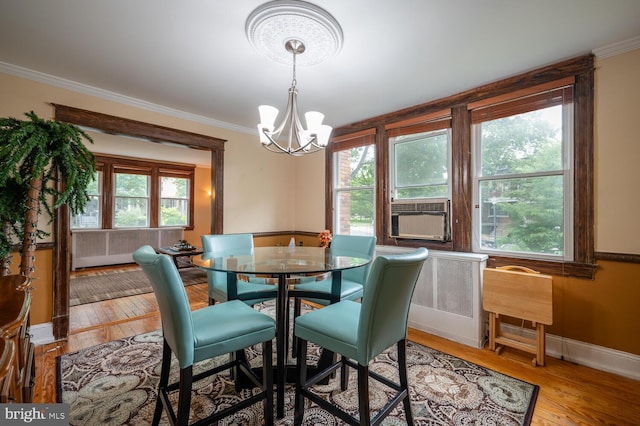 4800 Illinois Ave NW, Washington, DC 20011 - dining area with a chandelier, ornamental molding, wood finished floors, cooling unit, and baseboards