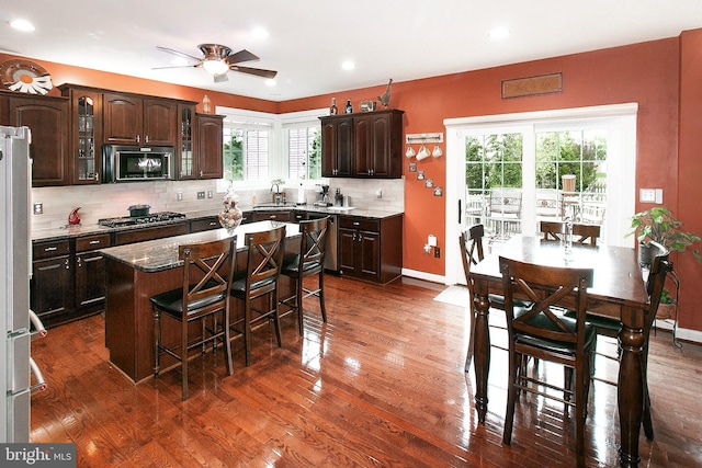 13763 Deacons Way, Gainesville, VA 20155 - kitchen featuring appliances with stainless steel finishes, a kitchen breakfast bar, dark wood-type flooring, recessed lighting, and plenty of natural light