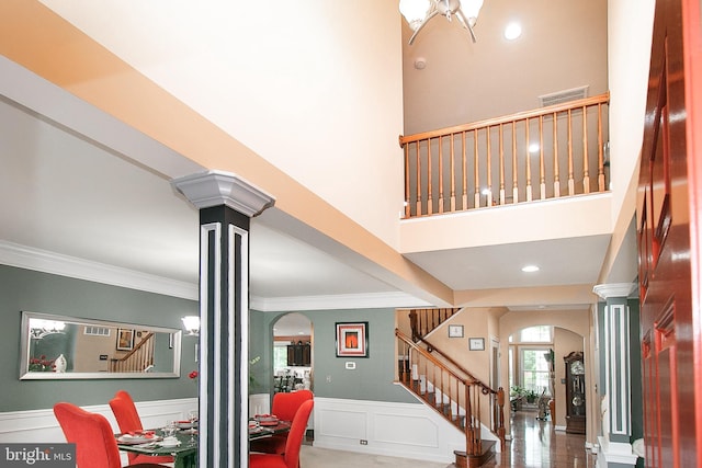 13763 Deacons Way, Gainesville, VA 20155 - stairway with arched walkways, decorative columns, ornamental molding, a wainscoted wall, and a decorative wall