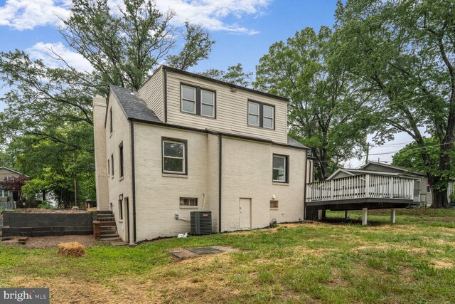 2908 Parkland Dr, District Heights, MD 20747 - rear view of house with central air condition unit, a deck, brick siding, and a yard