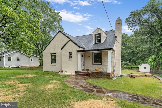 2908 Parkland Dr, District Heights, MD 20747 - view of front of house with a front lawn, a chimney, brick siding, a shingled roof, and a porch