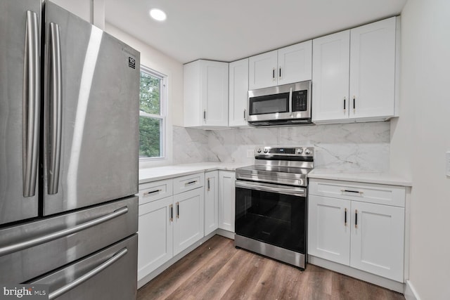 2908 Parkland Dr, District Heights, MD 20747 - kitchen with appliances with stainless steel finishes, dark wood-type flooring, decorative backsplash, white cabinets, and recessed lighting