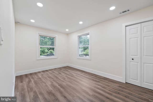 2908 Parkland Dr, District Heights, MD 20747 - unfurnished bedroom featuring multiple windows, wood finished floors, baseboards, a closet, and recessed lighting