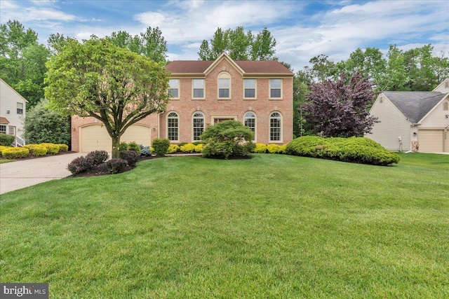 3026 5th St S, Voorhees, NJ 08043 - view of front of house with driveway, a front lawn, a garage, and brick siding