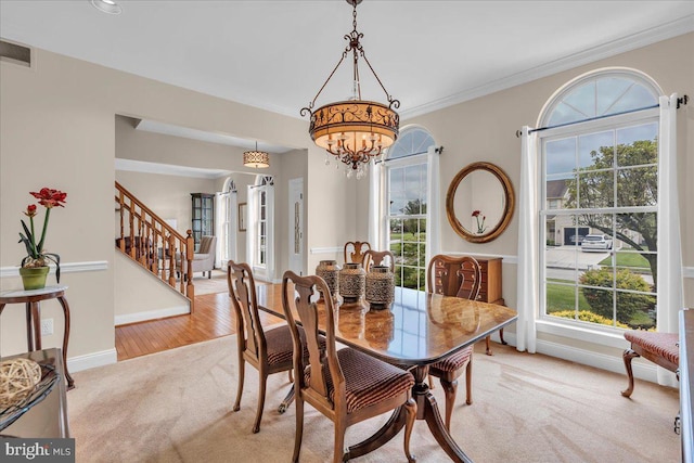 3026 5th St S, Voorhees, NJ 08043 - dining space featuring light colored carpet, stairs, baseboards, a chandelier, and ornamental molding