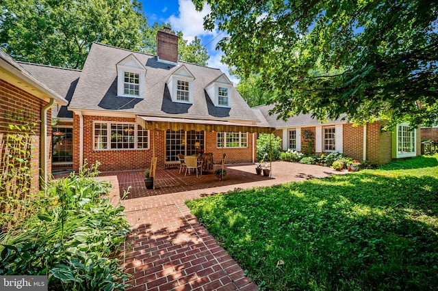 5702 Ainsley Garth, Baltimore, MD 21212 - back of property featuring a chimney, brick siding, a yard, and a patio area