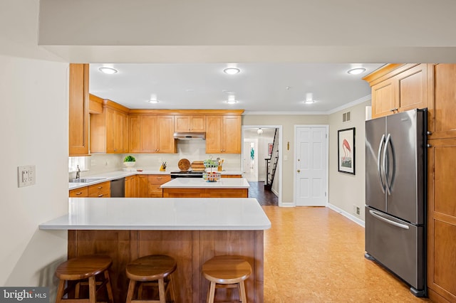 5702 Ainsley Garth, Baltimore, MD 21212 - kitchen with appliances with stainless steel finishes, light countertops, a breakfast bar area, a peninsula, and light flooring
