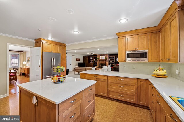 5702 Ainsley Garth, Baltimore, MD 21212 - kitchen with appliances with stainless steel finishes, ornamental molding, open floor plan, brown cabinets, and tasteful backsplash