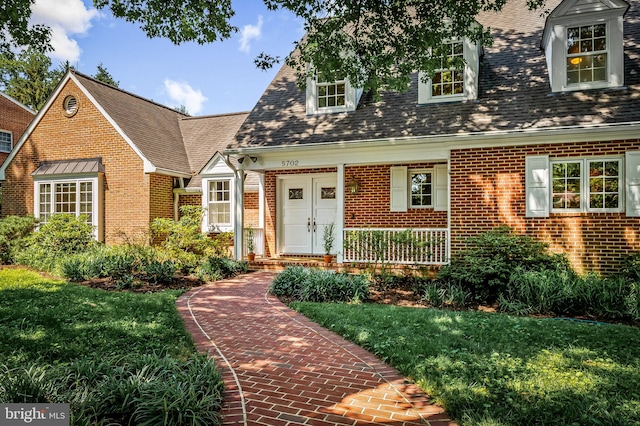 5702 Ainsley Garth, Baltimore, MD 21212 - cape cod home with brick siding, a front lawn, a shingled roof, and a porch
