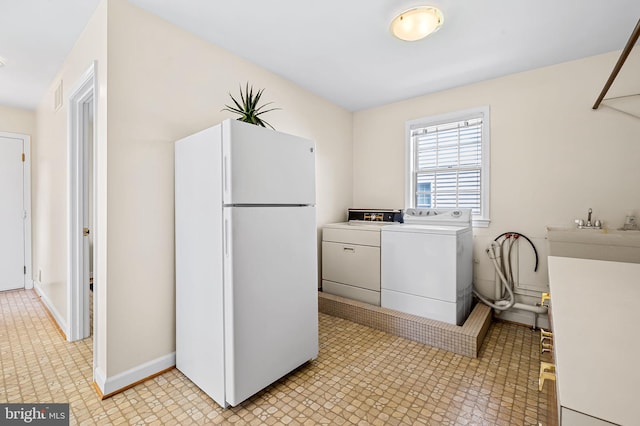 5702 Ainsley Garth, Baltimore, MD 21212 - washroom featuring washing machine and clothes dryer and baseboards