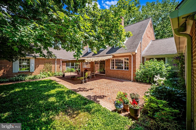5702 Ainsley Garth, Baltimore, MD 21212 - rear view of house with a patio, a yard, brick siding, and a shingled roof
