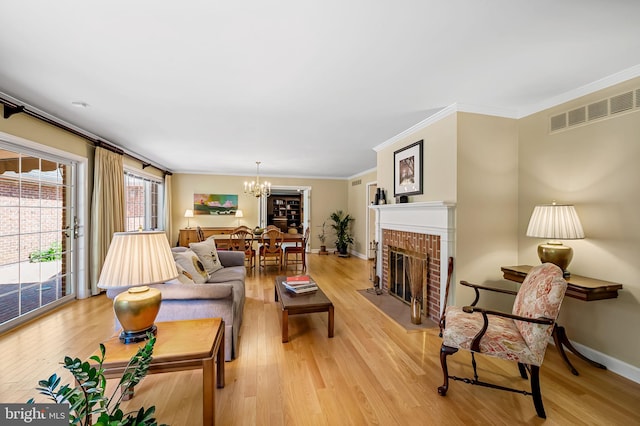 5702 Ainsley Garth, Baltimore, MD 21212 - living area with a chandelier, crown molding, light wood-style flooring, and a fireplace