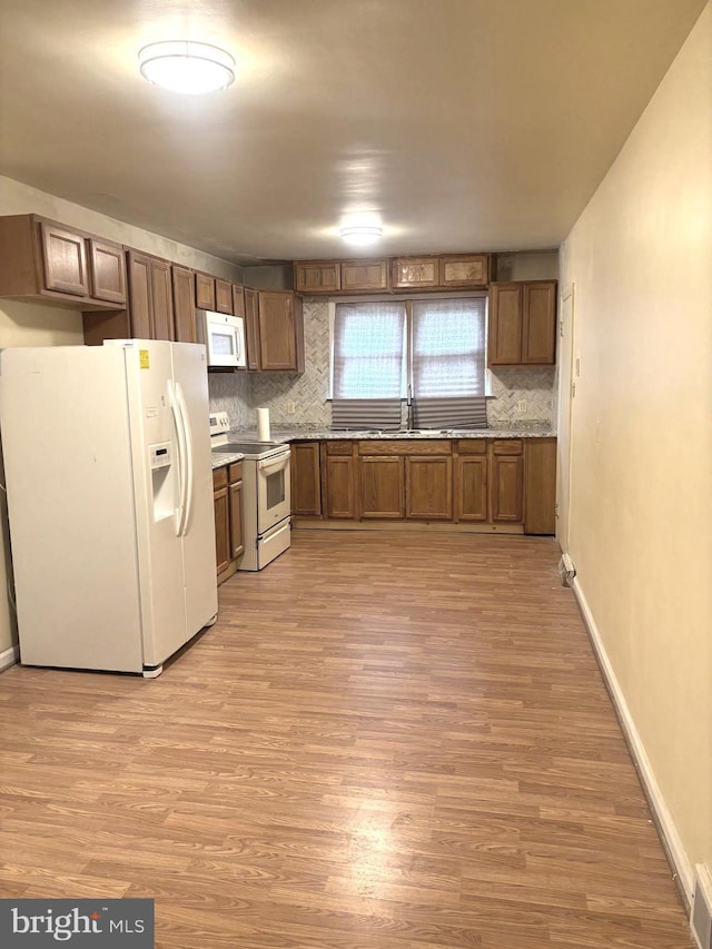423 S E Ave, Bridgeton, NJ 08302 - kitchen with white appliances, decorative backsplash, a sink, and baseboards