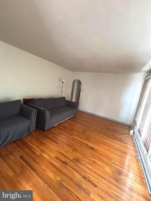 423 S E Ave, Bridgeton, NJ 08302 - living room with light wood finished floors, arched walkways, and baseboards