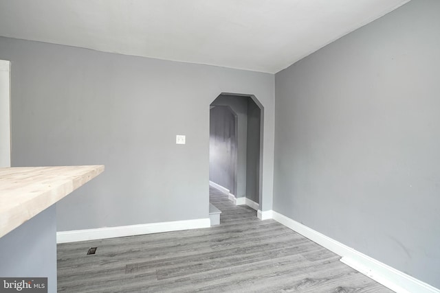 2933 Royden St, Camden, NJ 08105 - empty room featuring arched walkways, wood finished floors, and baseboards