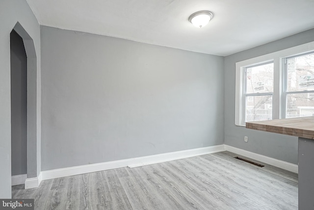 2933 Royden St, Camden, NJ 08105 - empty room with wood finished floors, baseboards, and arched walkways