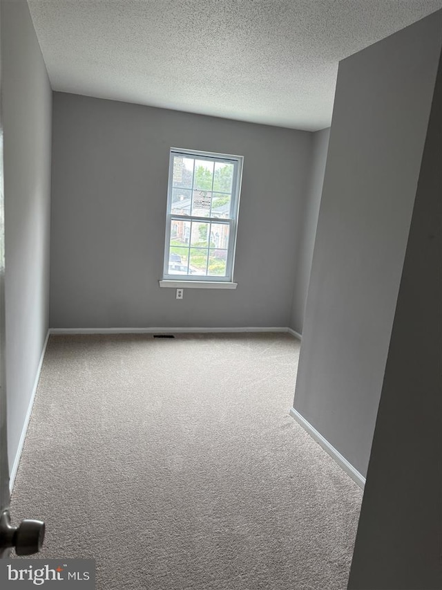 15368 Blacksmith Ter, Woodbridge, VA 22191 - carpeted empty room featuring a textured ceiling and baseboards