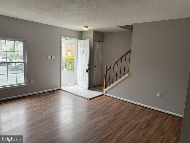 15368 Blacksmith Ter, Woodbridge, VA 22191 - foyer featuring wood finished floors, stairway, a textured ceiling, and baseboards