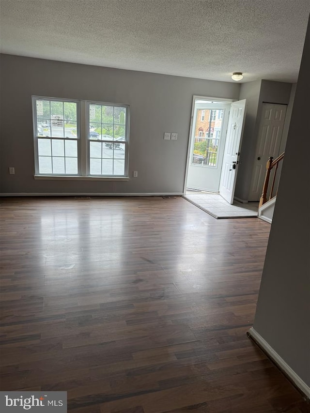 15368 Blacksmith Ter, Woodbridge, VA 22191 - empty room featuring a textured ceiling, dark wood-style floors, and baseboards