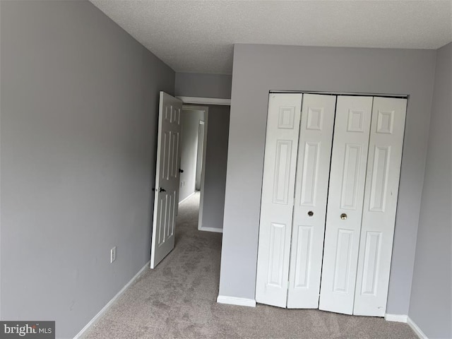 15368 Blacksmith Ter, Woodbridge, VA 22191 - unfurnished bedroom featuring carpet floors, a closet, baseboards, and a textured ceiling