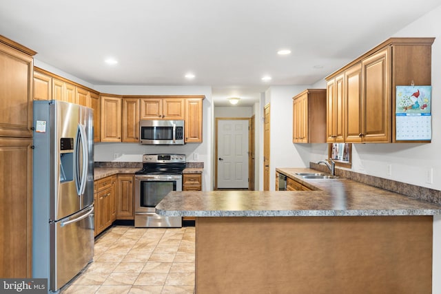 660 Bissetts Ln, Bloomsburg, PA 17815 - kitchen with appliances with stainless steel finishes, a sink, a peninsula, recessed lighting, and brown cabinets