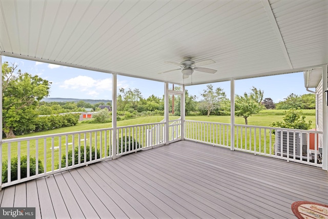 660 Bissetts Ln, Bloomsburg, PA 17815 - deck with a ceiling fan, view of wooded area, and a lawn