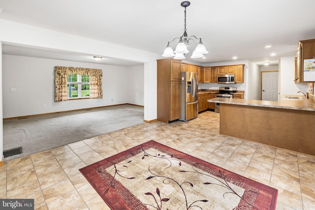 660 Bissetts Ln, Bloomsburg, PA 17815 - kitchen with appliances with stainless steel finishes, light colored carpet, a sink, open floor plan, and baseboards