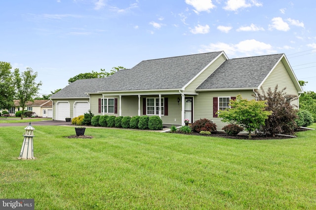 660 Bissetts Ln, Bloomsburg, PA 17815 - view of front of house with an attached garage, roof with shingles, asphalt driveway, and a front lawn