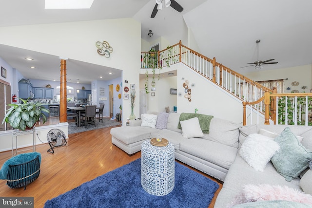 211 Spruce Trl, Woolwich Twp, NJ 08085 - living room with ceiling fan, stairs, wood finished floors, high vaulted ceiling, and a skylight