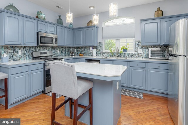 211 Spruce Trl, Woolwich Twp, NJ 08085 - kitchen featuring stainless steel appliances, a kitchen breakfast bar, and light wood-style floors