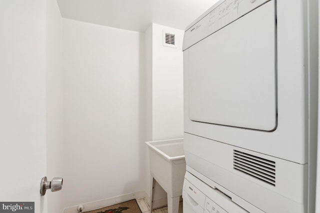 4100 Cathedral Ave NW Unit 709, Washington, DC 20016 - laundry area with stacked washer / drying machine and baseboards