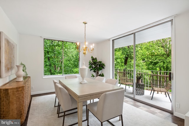 4100 Cathedral Ave NW Unit 709, Washington, DC 20016 - dining space with healthy amount of natural light, baseboards, a chandelier, and a wall of windows