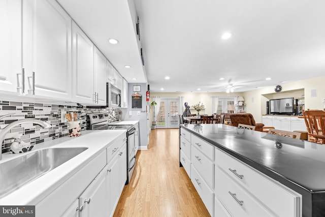 3420 Ponds Wood Ct, Huntingtown, MD 20639 - kitchen with stainless steel appliances, a sink, recessed lighting, light wood finished floors, and white cabinets