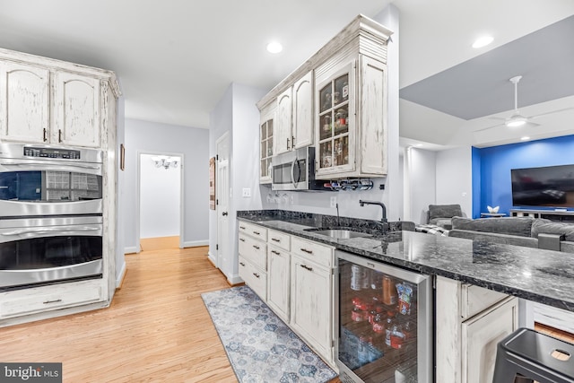 3420 Ponds Wood Ct, Huntingtown, MD 20639 - kitchen featuring beverage cooler, a sink, appliances with stainless steel finishes, glass insert cabinets, and open floor plan