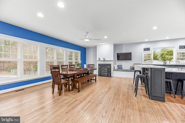 3420 Ponds Wood Ct, Huntingtown, MD 20639 - dining area with light wood-type flooring, a ceiling fan, a fireplace, and recessed lighting