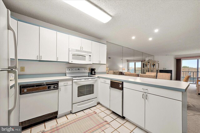 106 120th St Unit 303, Ocean City, MD 21842 - kitchen with white appliances, a peninsula, light countertops, recessed lighting, and open floor plan
