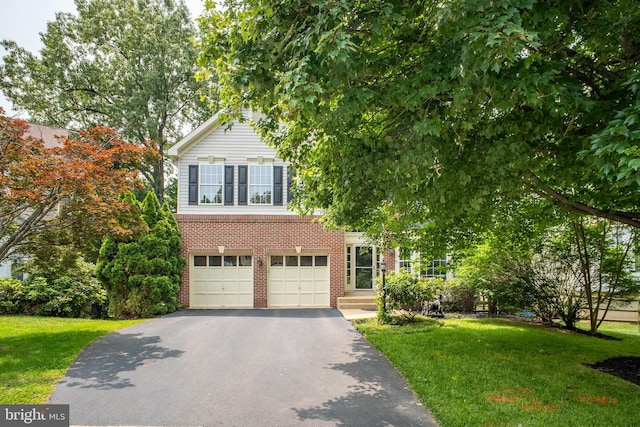 47561 Hidden Cove Ct, Sterling, VA 20165 - view of property hidden behind natural elements with asphalt driveway, brick siding, a front lawn, and an attached garage