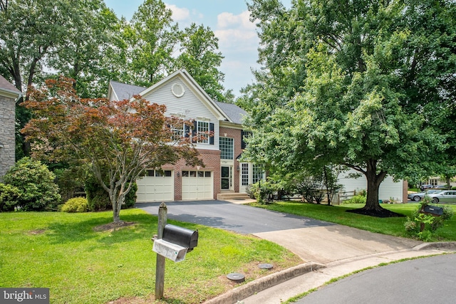 47561 Hidden Cove Ct, Sterling, VA 20165 - traditional-style house with asphalt driveway, an attached garage, a front lawn, and brick siding