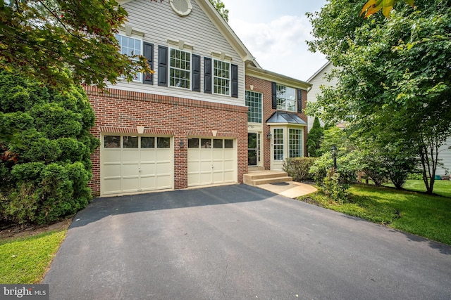 47561 Hidden Cove Ct, Sterling, VA 20165 - view of front facade with brick siding, an attached garage, and asphalt driveway