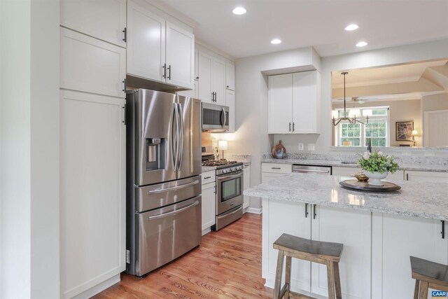 2667 Aldersgate Way, Charlottesville, VA 22911 - kitchen with appliances with stainless steel finishes, a breakfast bar, white cabinetry, light wood-style flooring, and recessed lighting