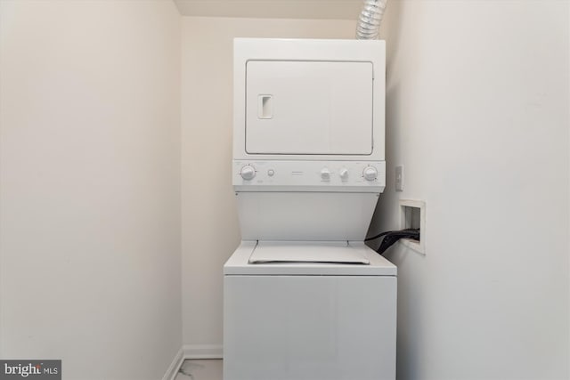 1136 Cove Rd Unit 202, Annapolis, MD 21403 - washroom featuring stacked washer / dryer and baseboards