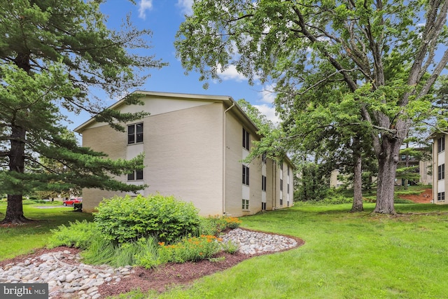 1136 Cove Rd Unit 202, Annapolis, MD 21403 - view of home's exterior featuring a lawn and stucco siding