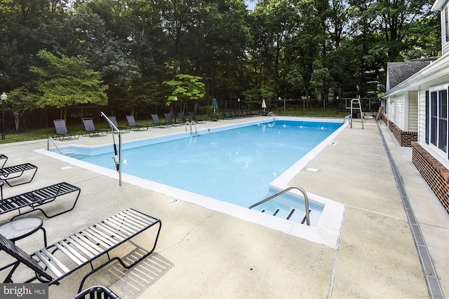 1136 Cove Rd Unit 202, Annapolis, MD 21403 - community pool featuring a patio area and view of wooded area