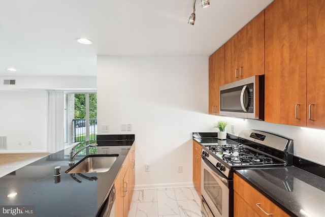 1136 Cove Rd Unit 202, Annapolis, MD 21403 - kitchen with stainless steel appliances, a sink, dark stone countertops, brown cabinets, and recessed lighting