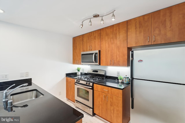 1136 Cove Rd Unit 202, Annapolis, MD 21403 - kitchen featuring stainless steel appliances, a sink, and brown cabinetry