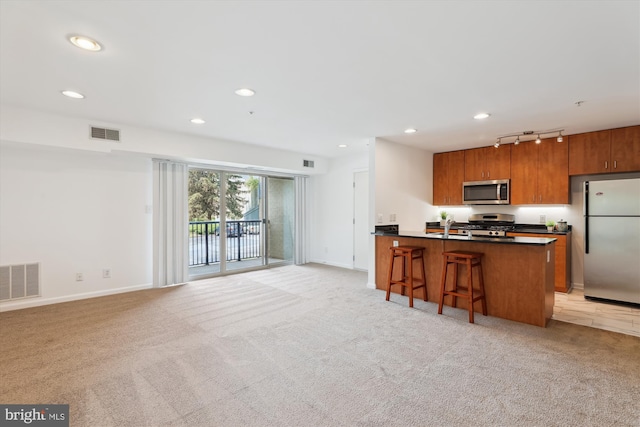 1136 Cove Rd Unit 202, Annapolis, MD 21403 - kitchen featuring appliances with stainless steel finishes, rail lighting, dark countertops, brown cabinets, and baseboards