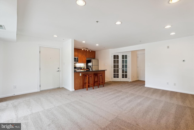 1136 Cove Rd Unit 202, Annapolis, MD 21403 - living room with light carpet, recessed lighting, baseboards, and french doors