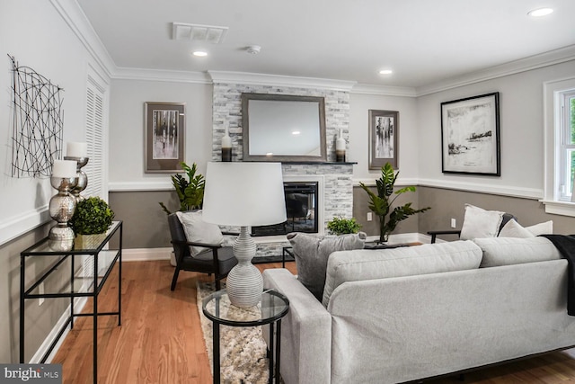 3402 Halloway S, Upper Marlboro, MD 20772 - living area with wood finished floors, a large fireplace, ornamental molding, baseboards, and recessed lighting